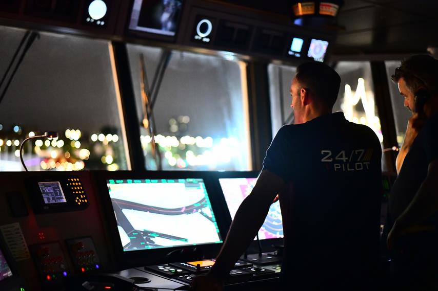Seafarer on bridge in dark